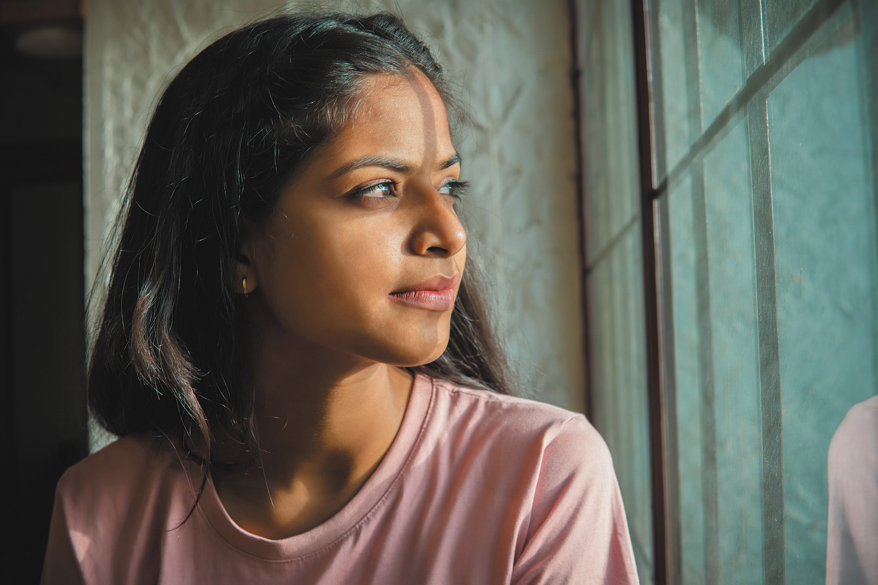 woman looking out window wide